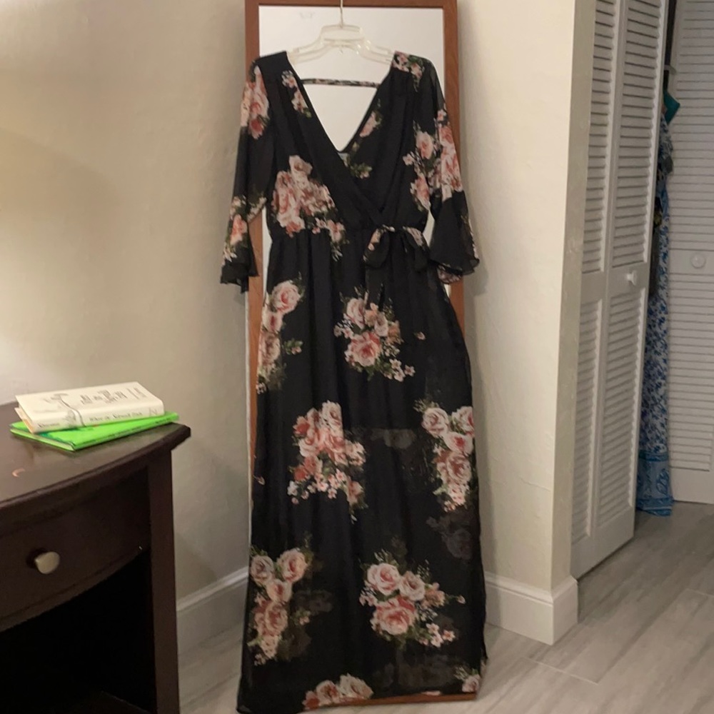 Floral dress. V neck and back. Bow around waist. Short black skirt underneath.